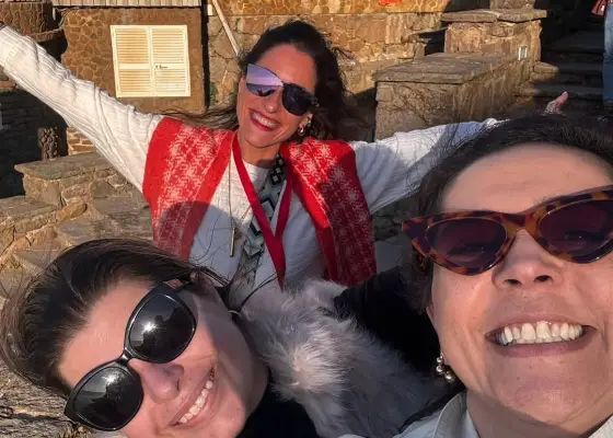 Three women sharing a sunny YourTuk moment
